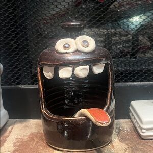 Playful Brown and White Ceramic Creature by [Brand]